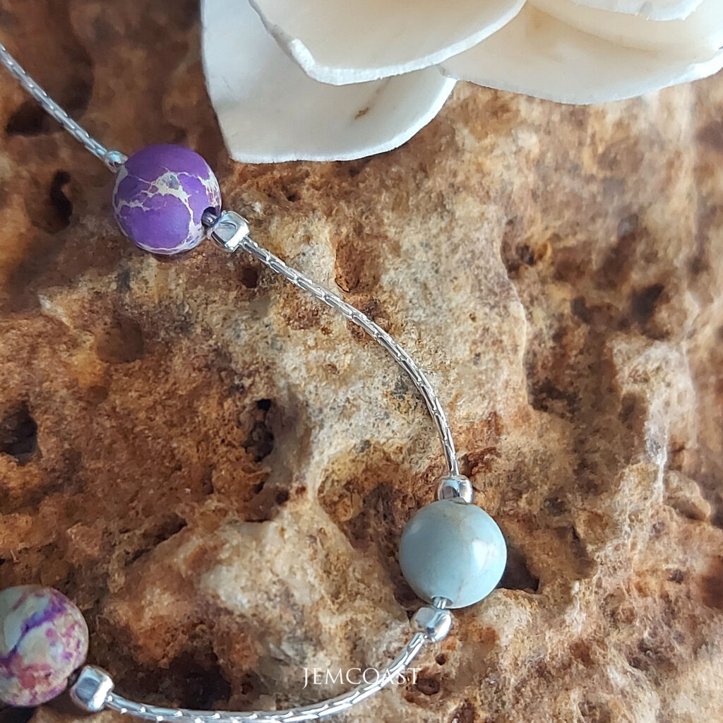 DELICATE JASPER BRACELET Add elegance to your wrist with this thin beaded jasper bracelet. Handcrafted with sterling silver and Jasper Beads, this colorful piece features beautiful shades of purple. Elevate your accessory game with this unique and vibrant Gemstone bracelet. Perfect for adding a touch of boho chic to any outfit!